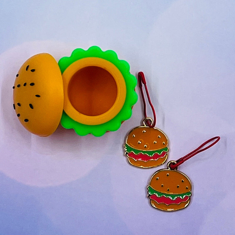 Mini silicone burger-shaped jar with two enamel burger-shaped knitting and crochet stitch markers